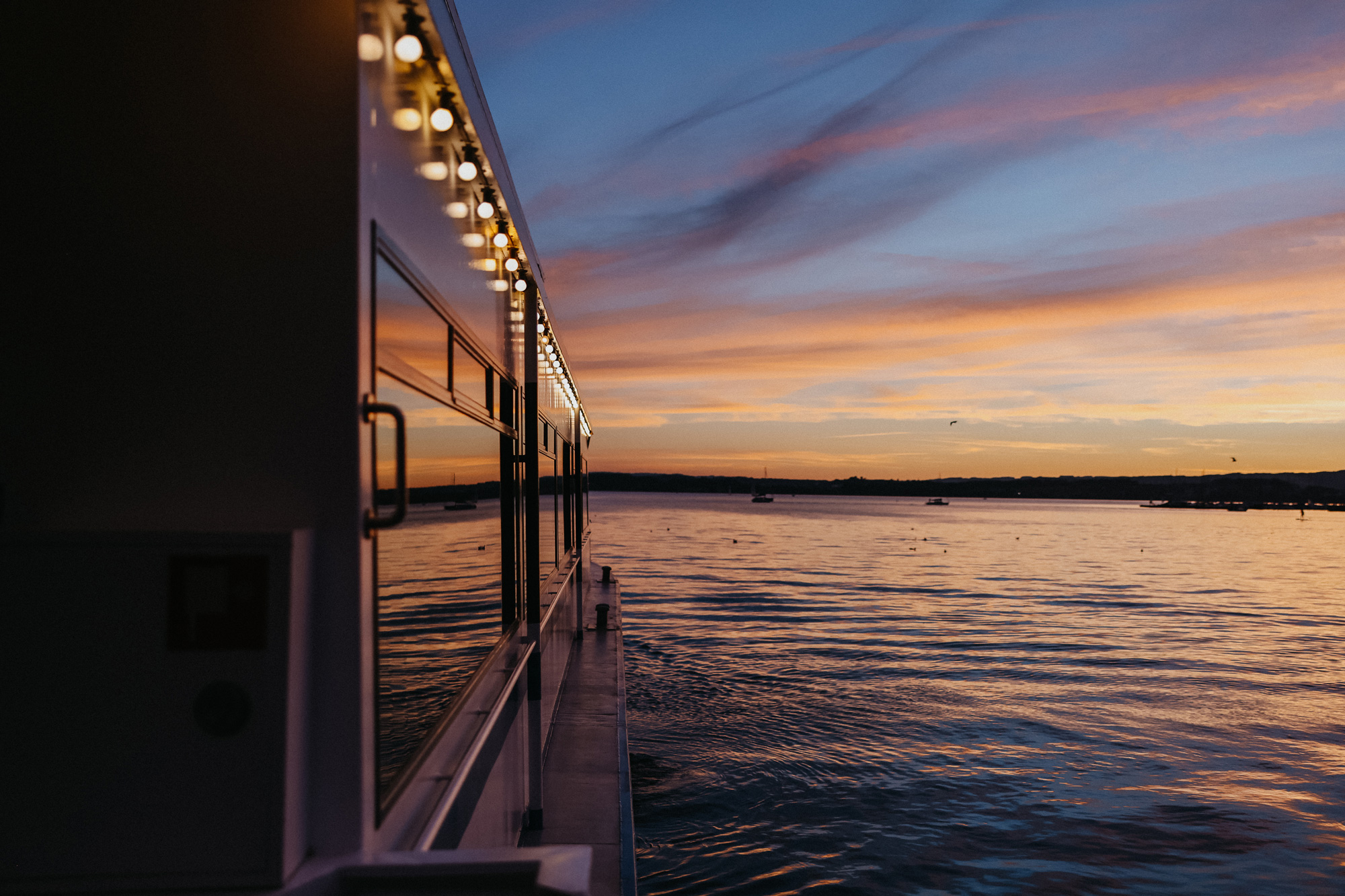 Evening mood Sunset Lake Zug boat Port side view of the orange-coloured lake at sunset