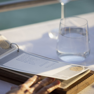Menu card on table with water glass in the background