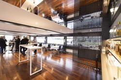 Guests in the lounge with mirrored ceiling and bar with drinks bottles