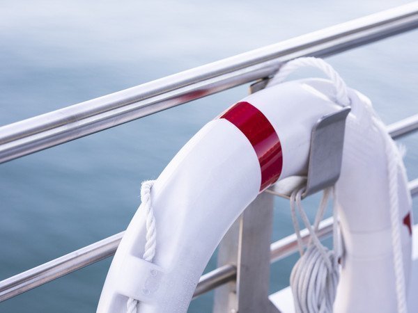Lifebuoy on the railing with the sea in the background