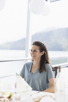 Portrait of an employee sitting at a table on the outside deck