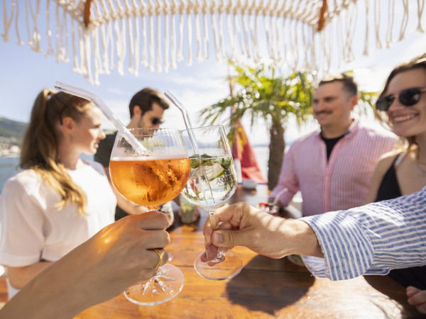 Young people toast with aperitif glasses