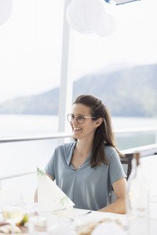 Portrait of an employee sitting at a table on the outside deck