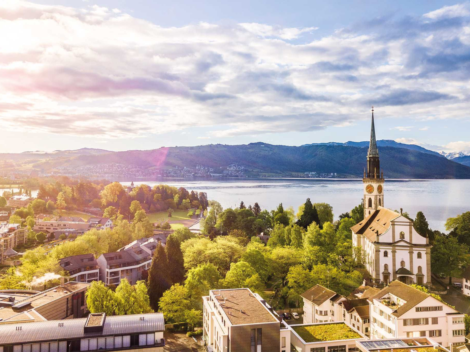 Aerial view of Cham with church tower and Lake Zug in the background