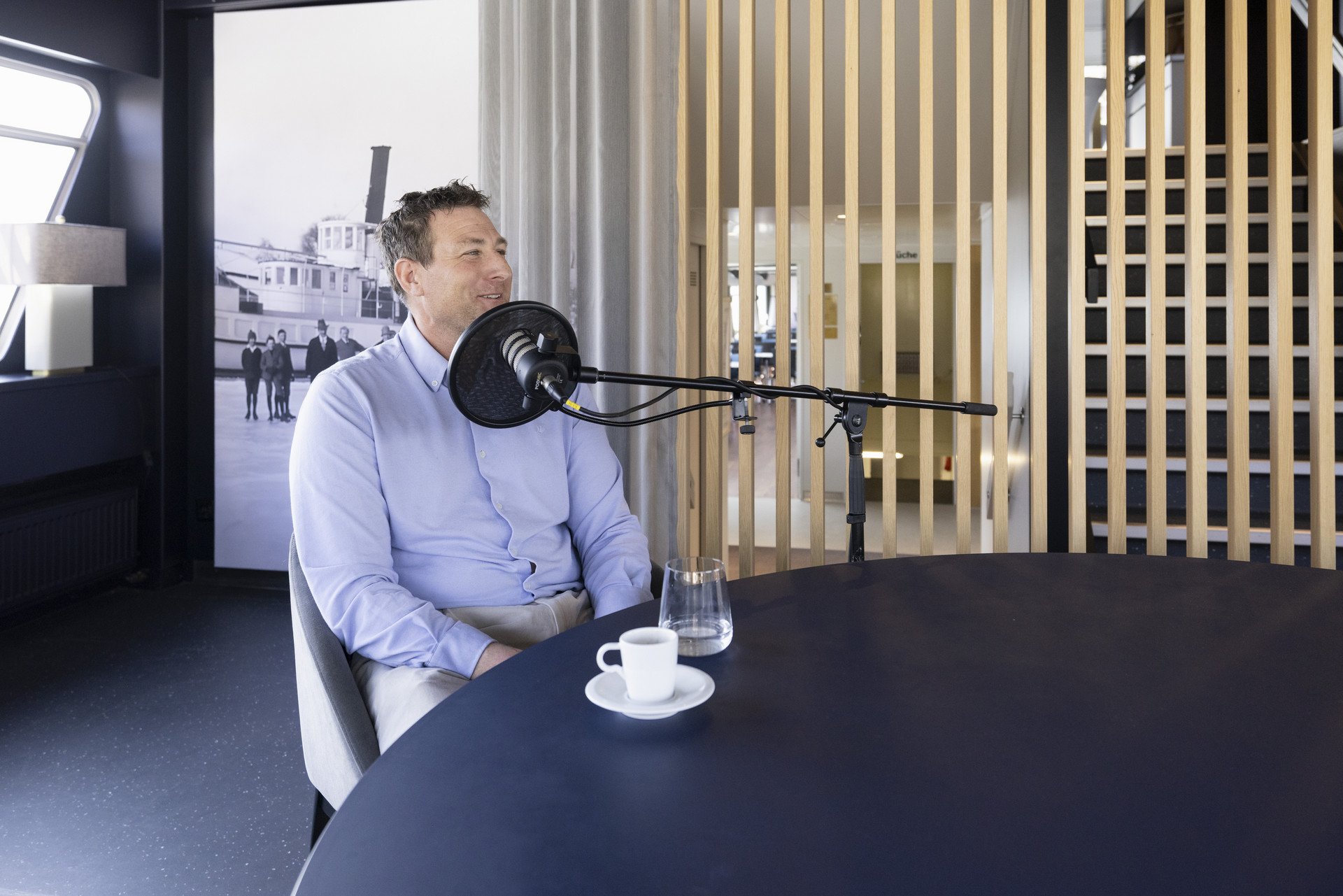 Damian Weiss hinter dem Mikrophon am Podcast-Tisch