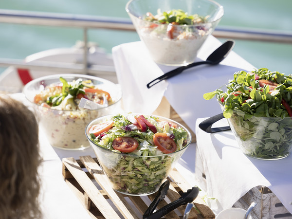 Salad buffet with water in the background