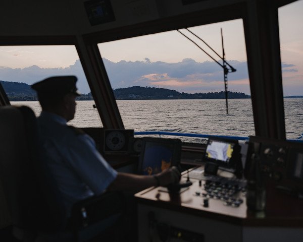 Skipper at the helm on an evening cruise