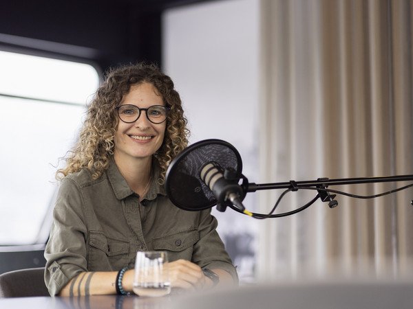 Porträt von Eila Bredehöft vor dem Podcast Mikrophon